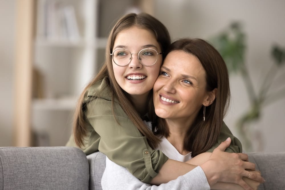 Mother and daughter hugging - Dentist in Grand Ledge, MI.
