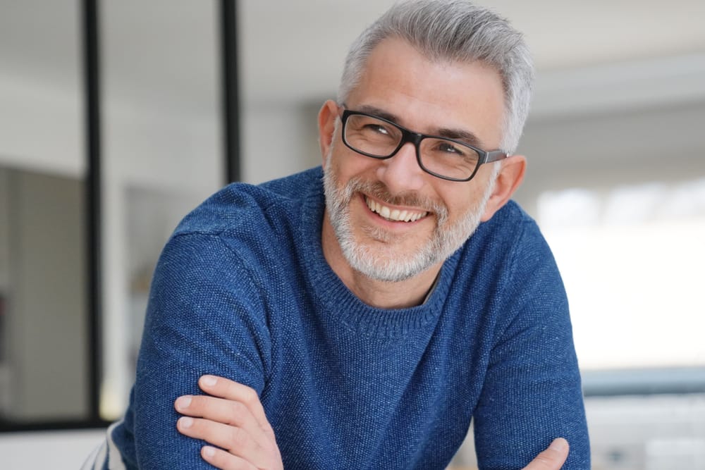 Mature Man Smiling with Confidence After Dental Care - Fillings Handsome mature man smiling confidently, reflecting the benefits of professional dental treatment and oral health maintenance. - Fillings